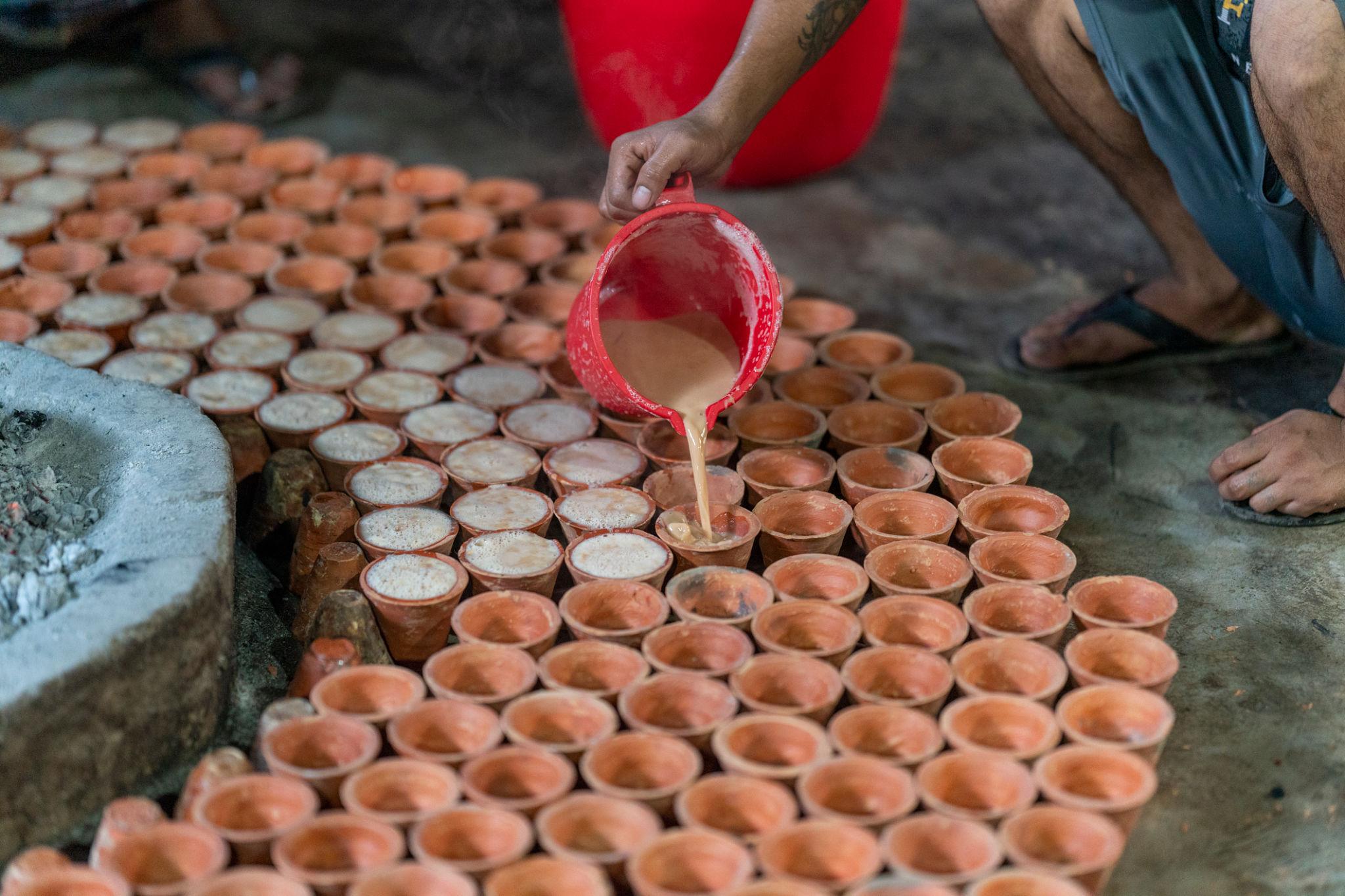 Clay pots around a bonfire to make traditional yogurt, Rajshahi Division, Bogura, Bangladesh. Delicious curd, dahi, doi or bangladeshi sweet yogurt.